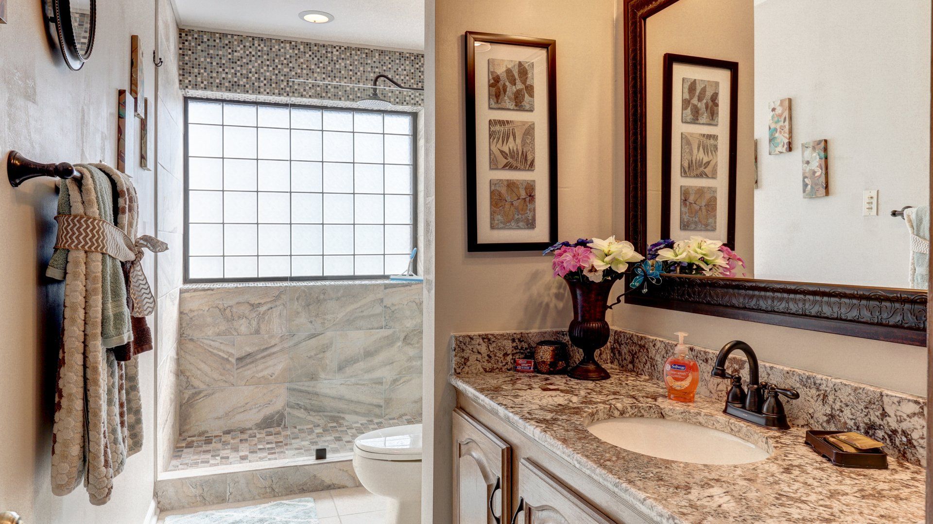 A bathroom with a sink , toilet , and mirror.