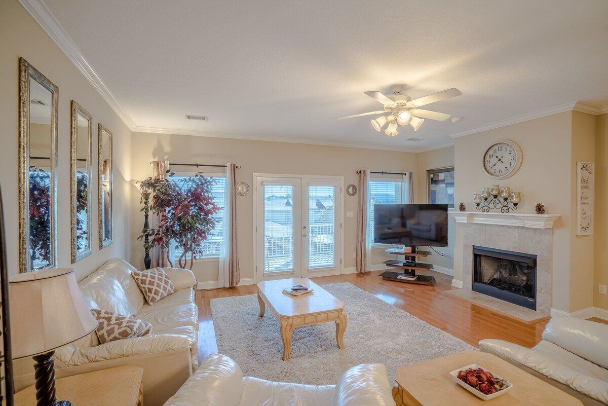 A living room with a fireplace and a flat screen tv