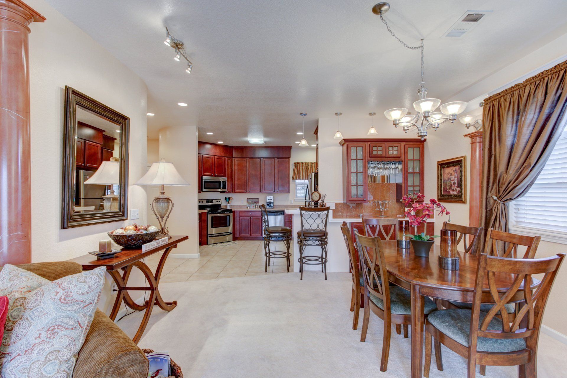 A living room with a dining room table and chairs