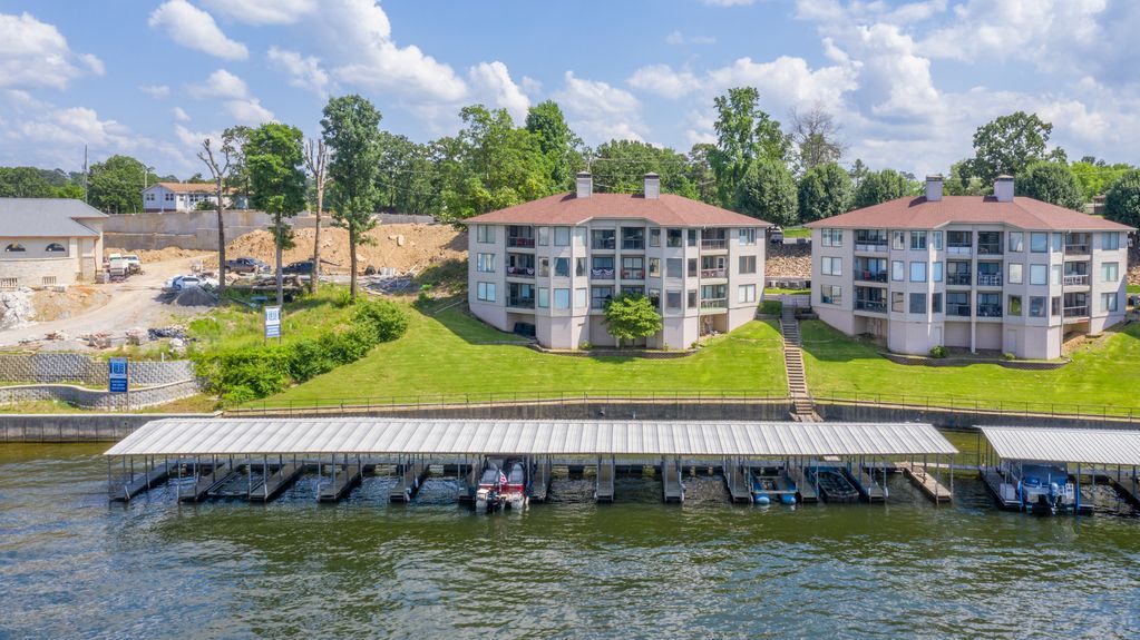 An aerial view of a row of apartment buildings next to a body of water.