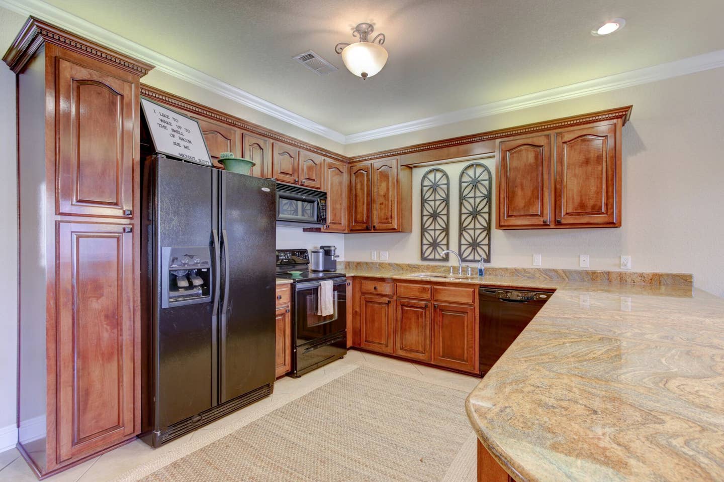 A kitchen with stainless steel appliances and wooden cabinets