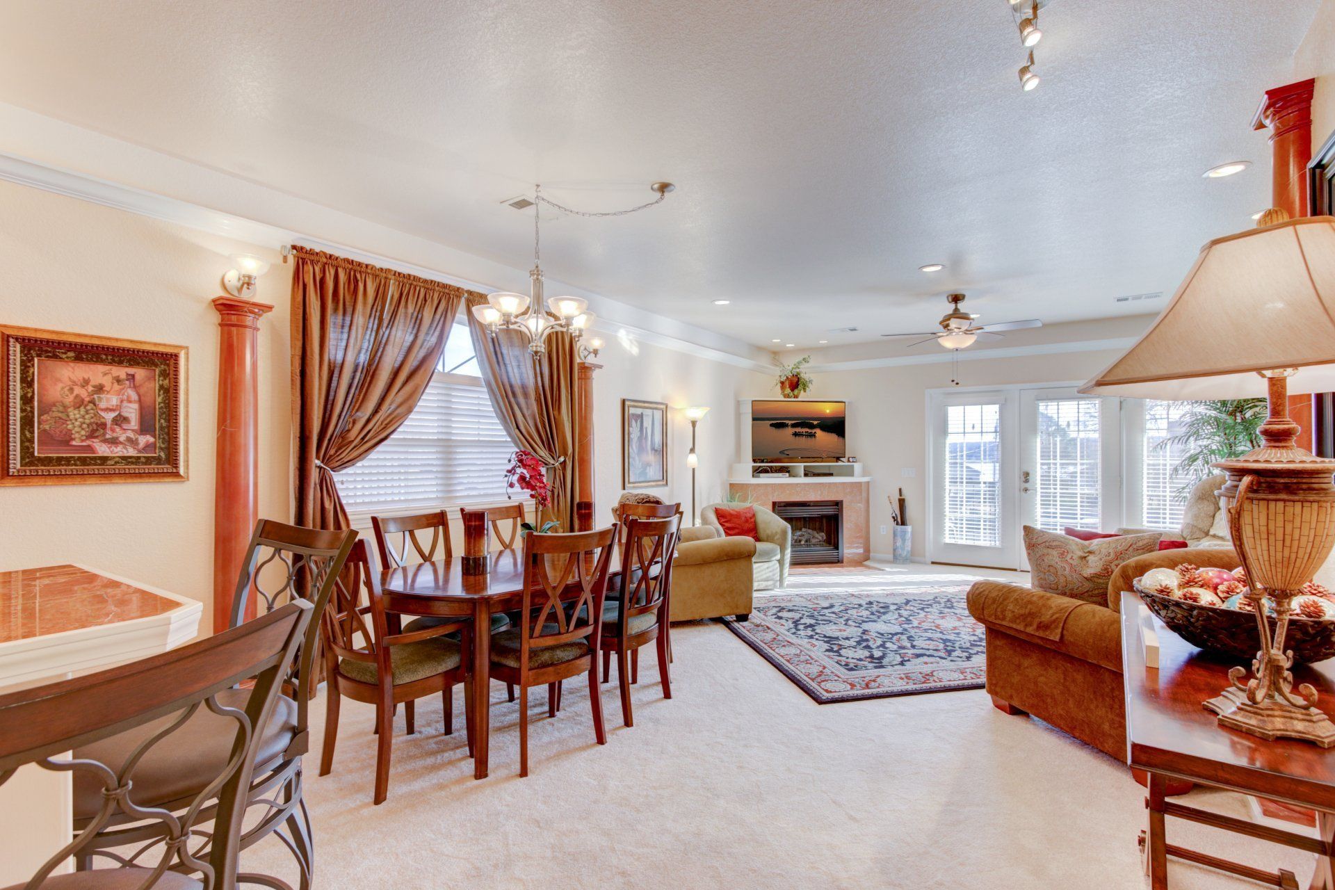 A living room with a table and chairs and a lamp
