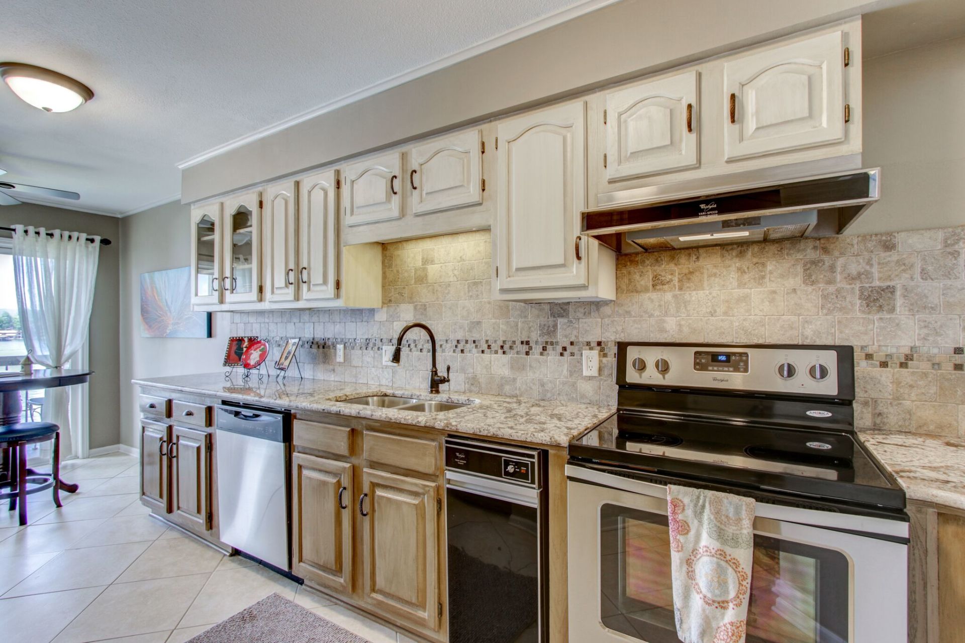 A kitchen with stainless steel appliances and wooden cabinets.