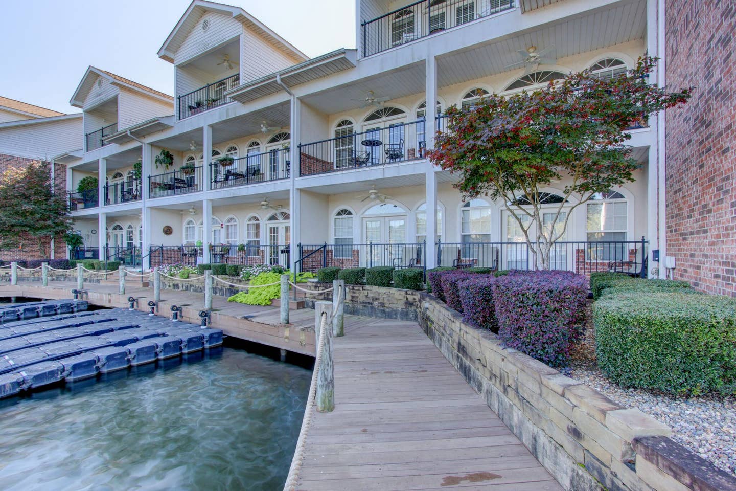 A large building with a dock in front of it next to a body of water.