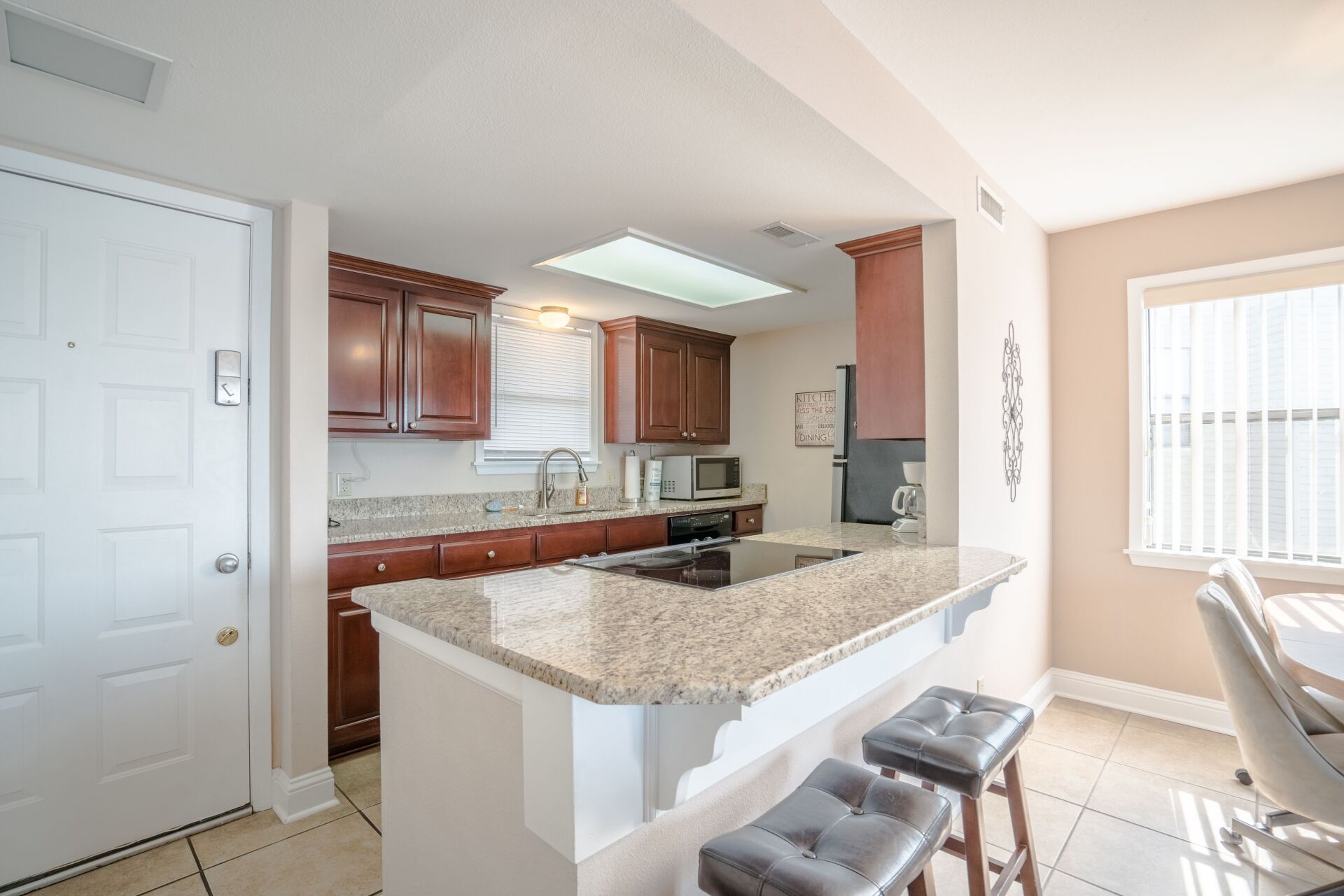 A kitchen with granite counter tops and wooden cabinets
