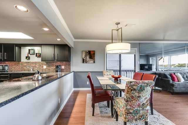 A kitchen and dining room with a table and chairs