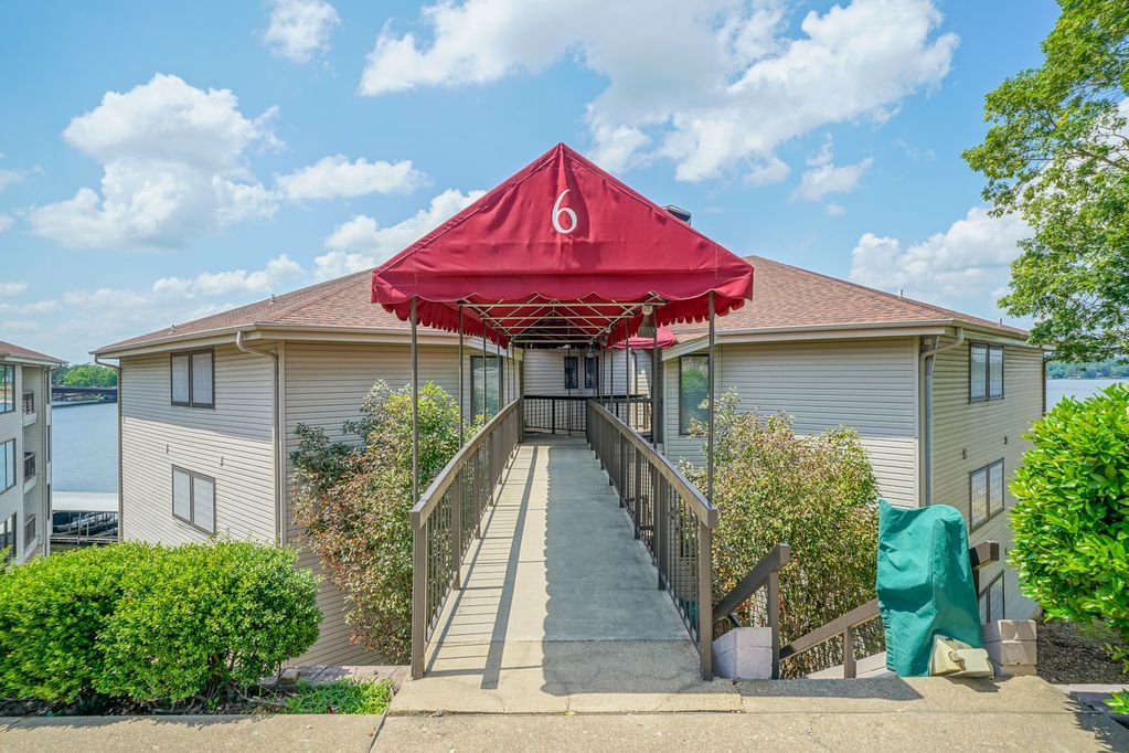 A building with a red canopy and a ramp leading to it