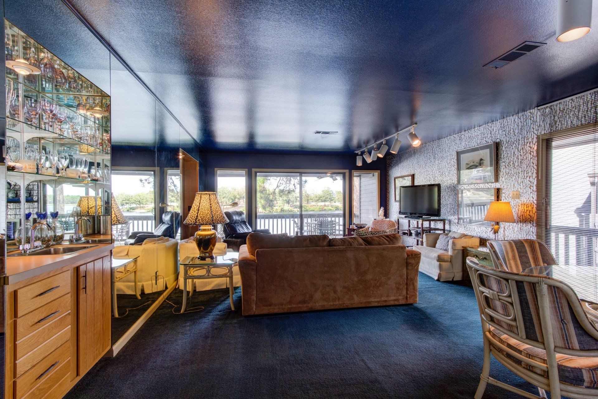 A living room with a couch , chairs and a bar
