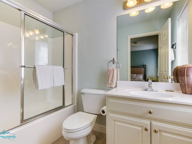 A bathroom with a toilet , sink , and bathtub.