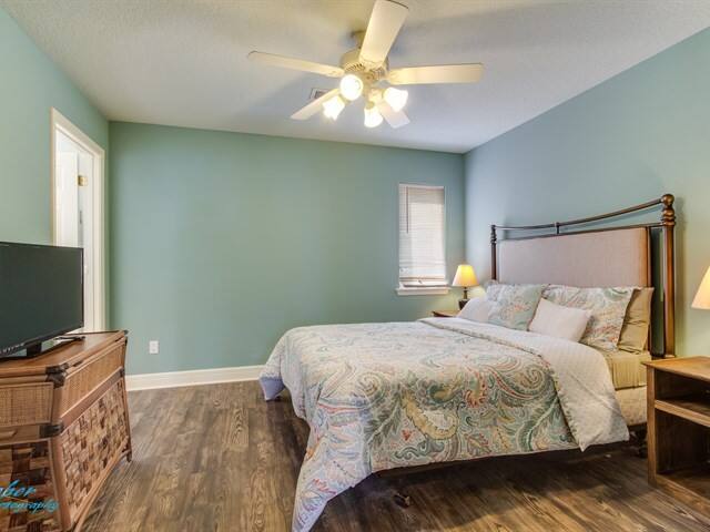A bedroom with a king size bed and a flat screen tv