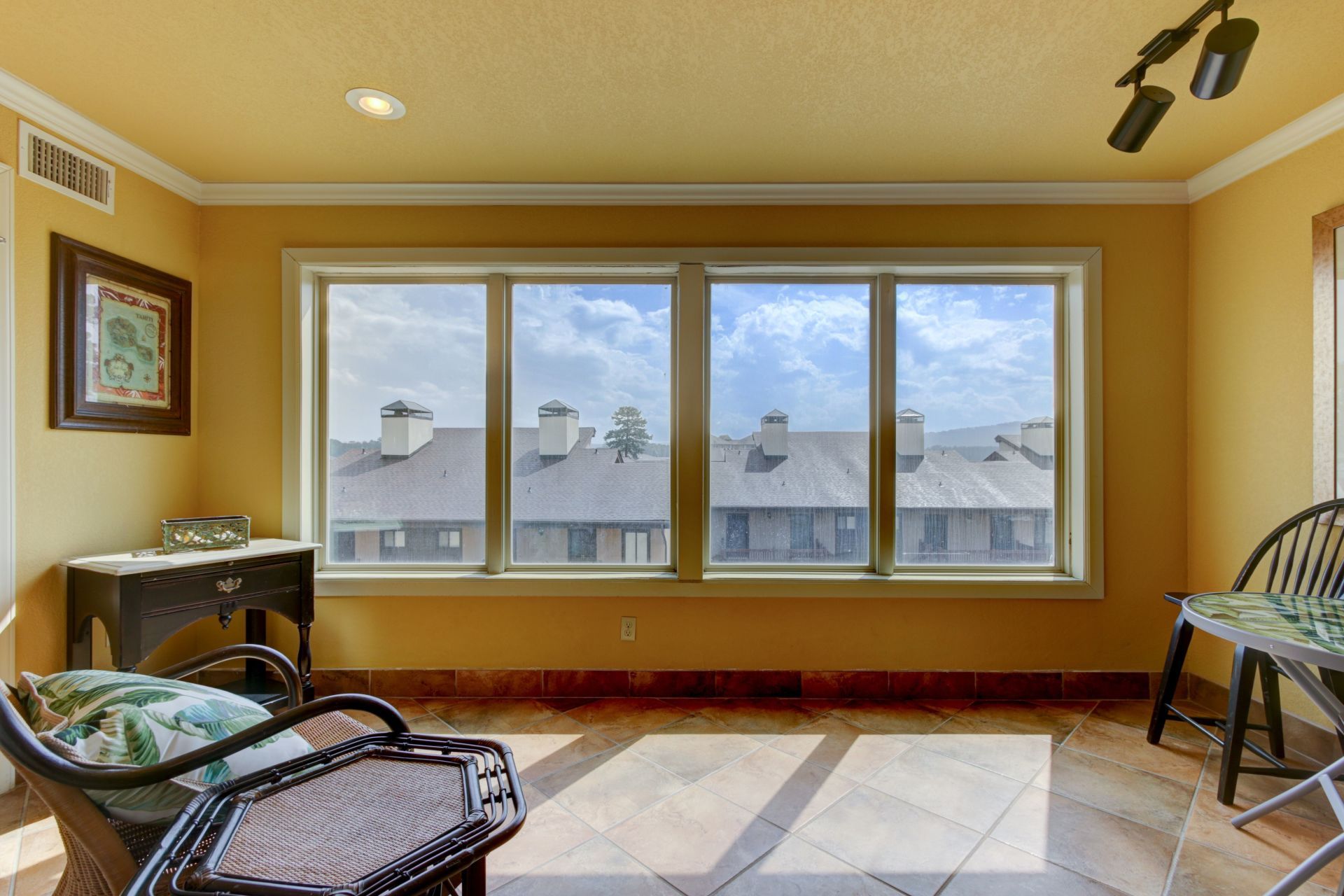 A room with a lot of windows and a ceiling fan