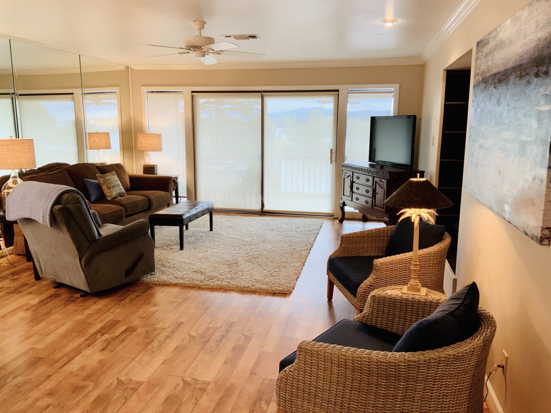 A living room with a couch , chairs and a television