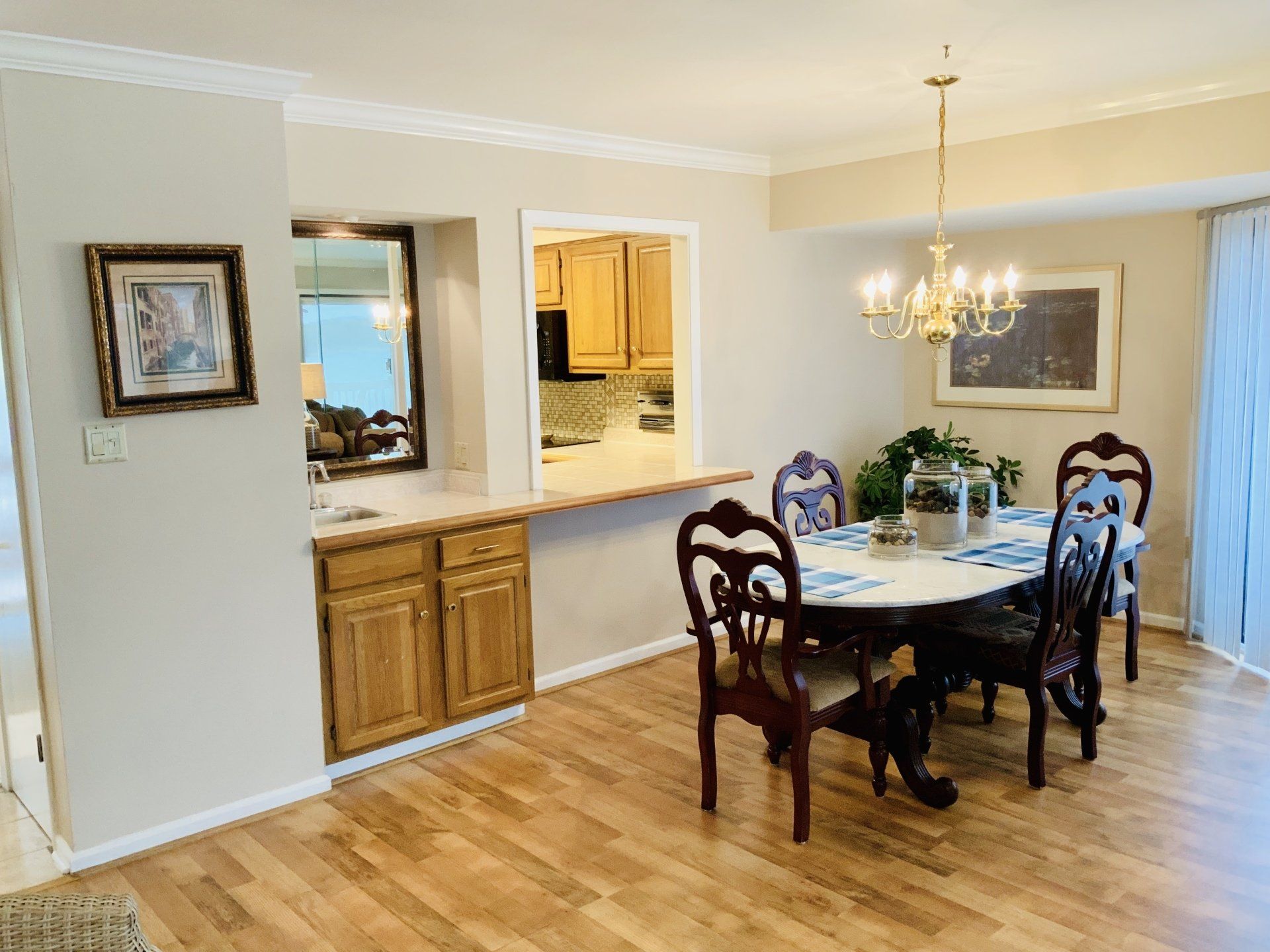 A dining room with a table and chairs and a chandelier.