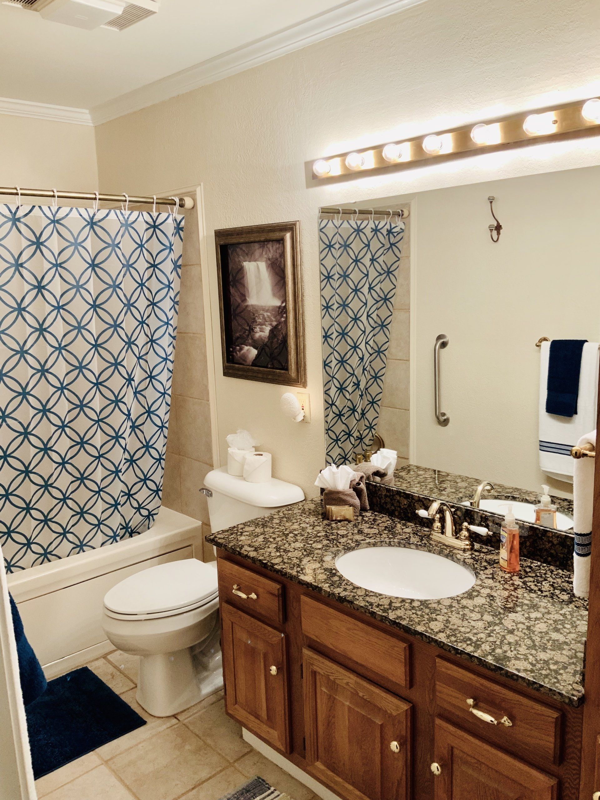 A bathroom with a toilet a sink and a shower