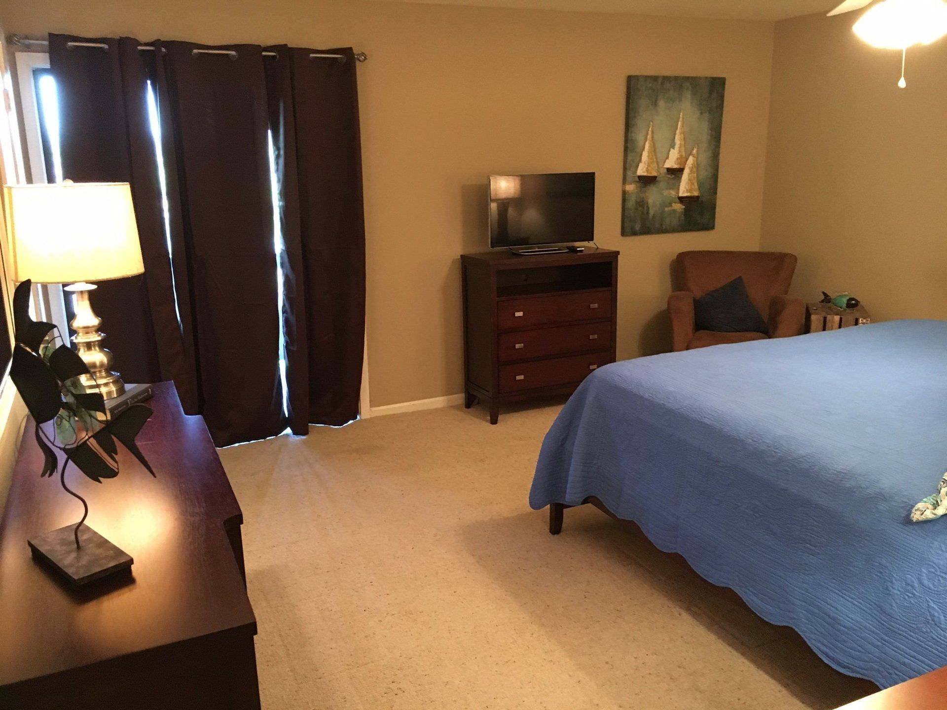 A bedroom with a large bed and a television