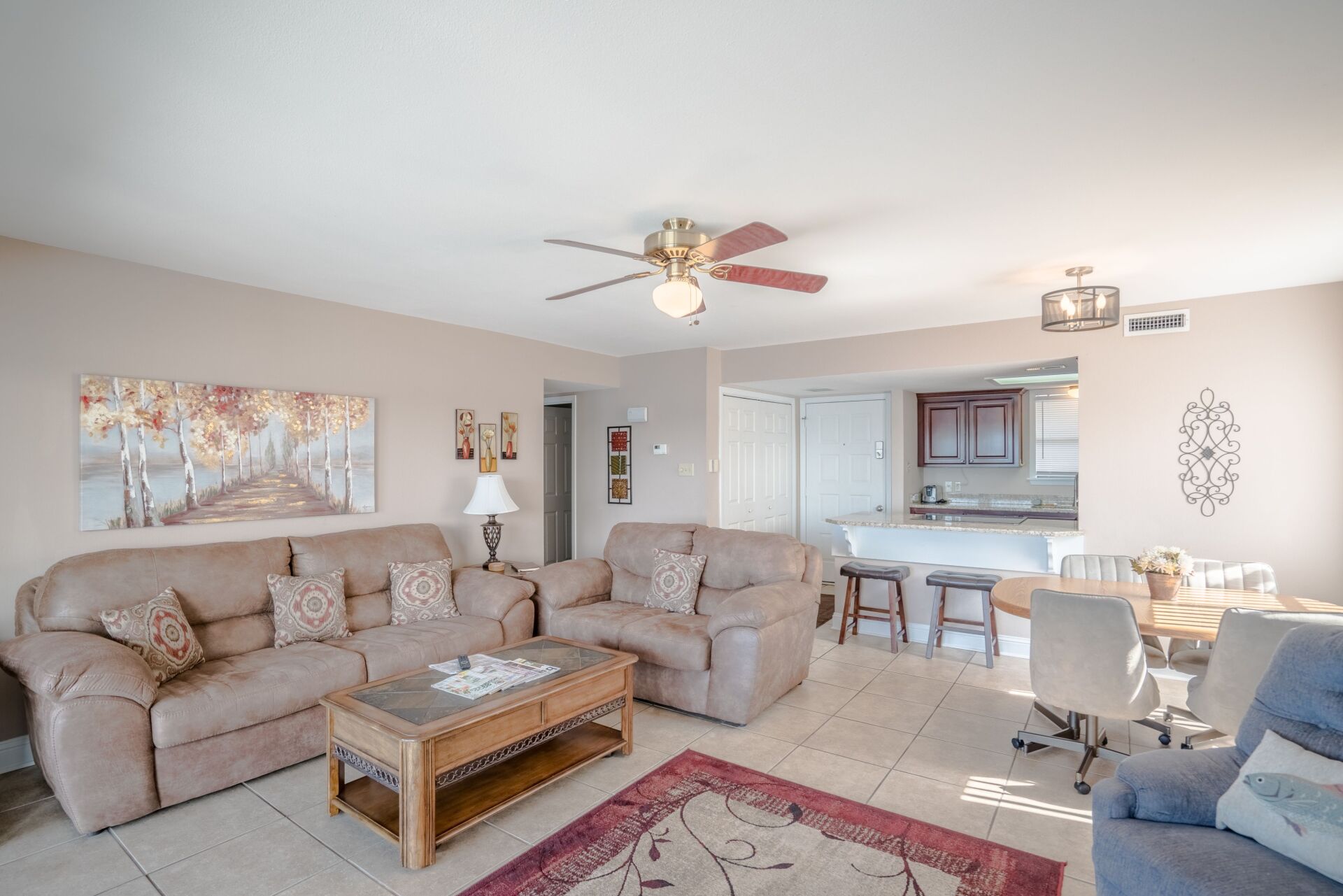 A living room filled with furniture and a ceiling fan.