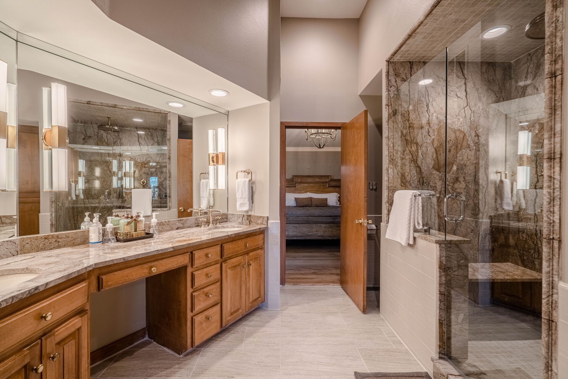A bathroom with two sinks and a walk in shower.