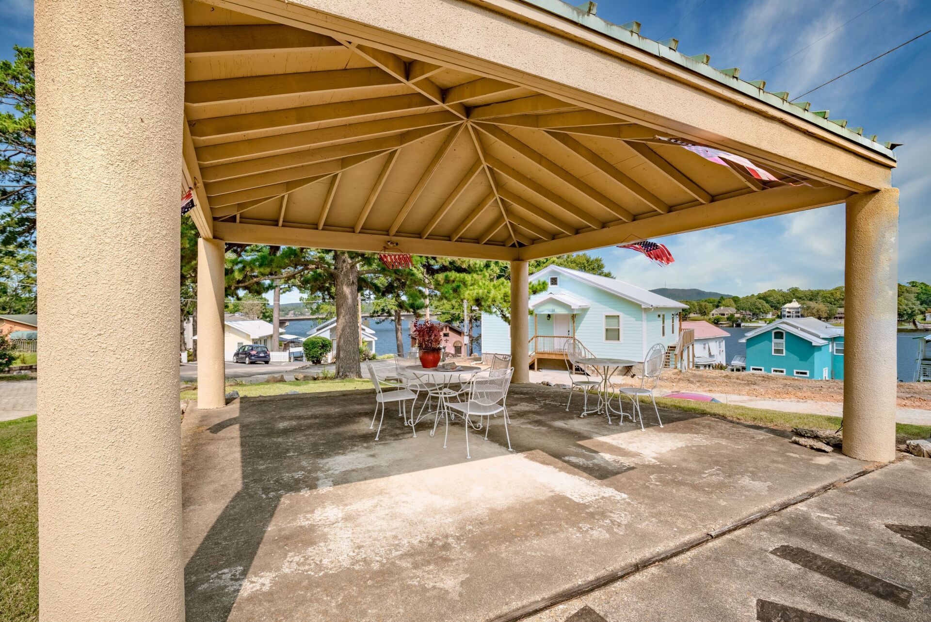 A gazebo with a table and chairs underneath it in a park.