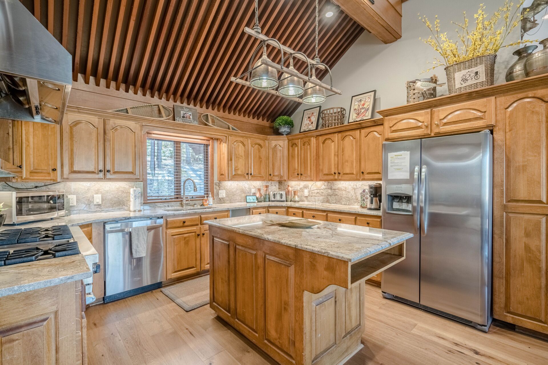 A kitchen with wooden cabinets and stainless steel appliances.