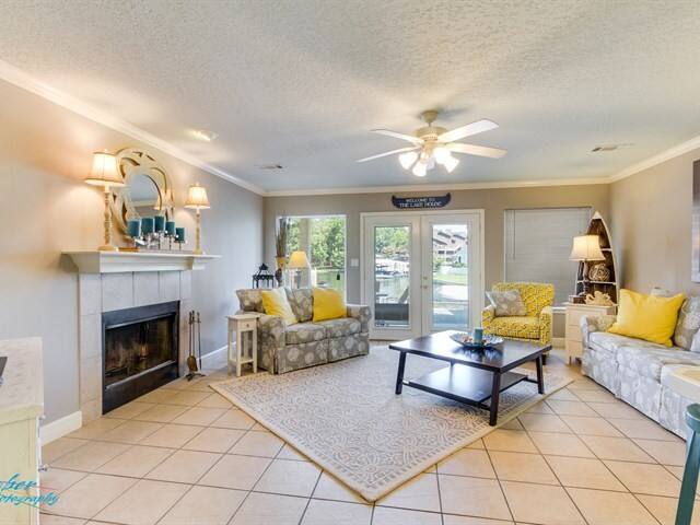 A living room with a fireplace and a ceiling fan