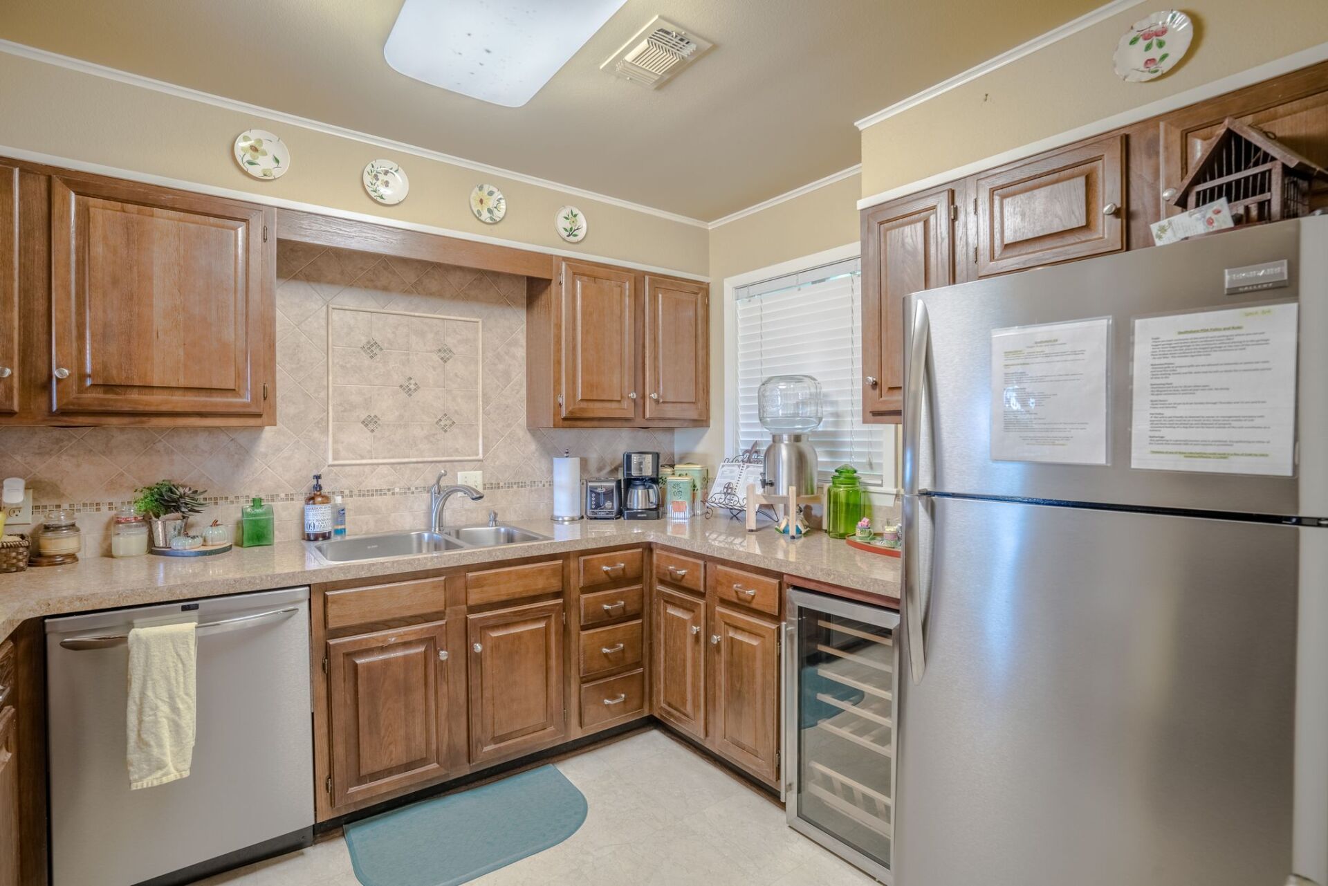 A kitchen with stainless steel appliances and wooden cabinets.