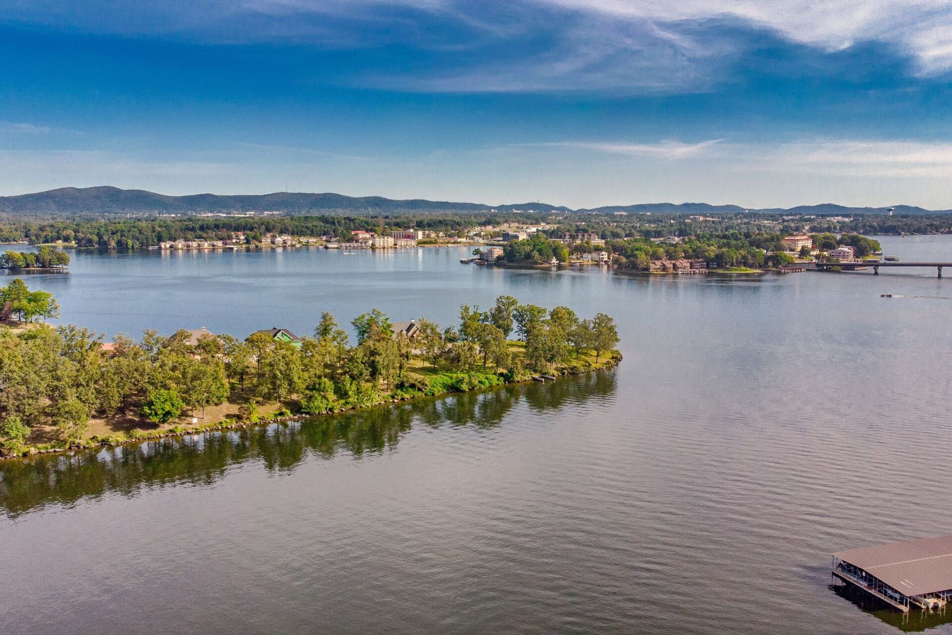 An aerial view of a lake with a small island in the middle.