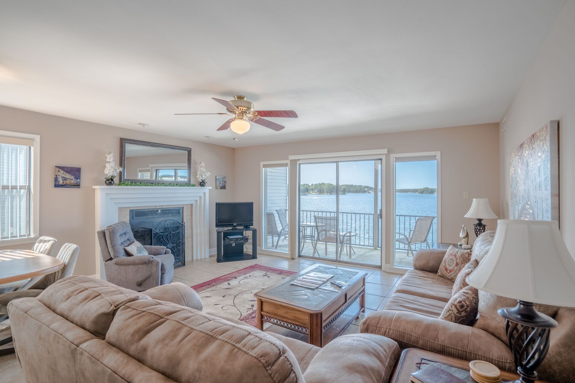 A living room filled with furniture and a ceiling fan.
