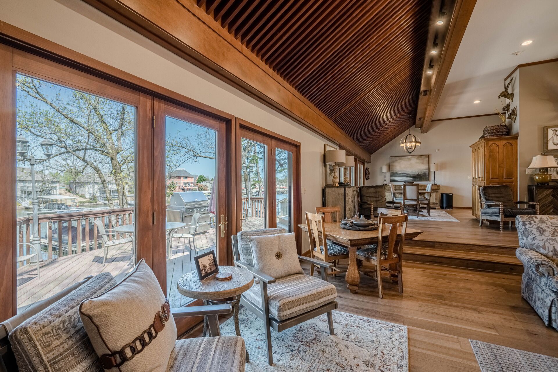 A living room with a lot of windows and furniture.