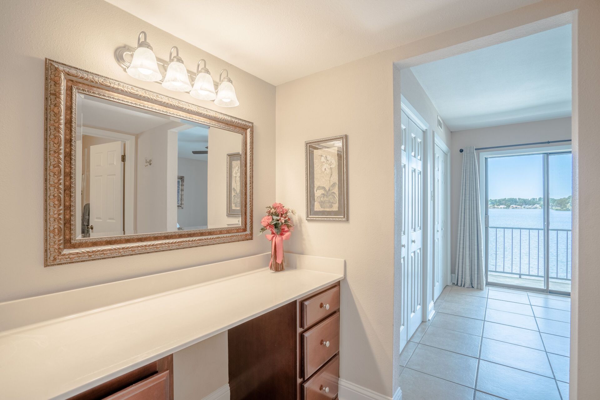 There is a large mirror on the wall in the hallway.