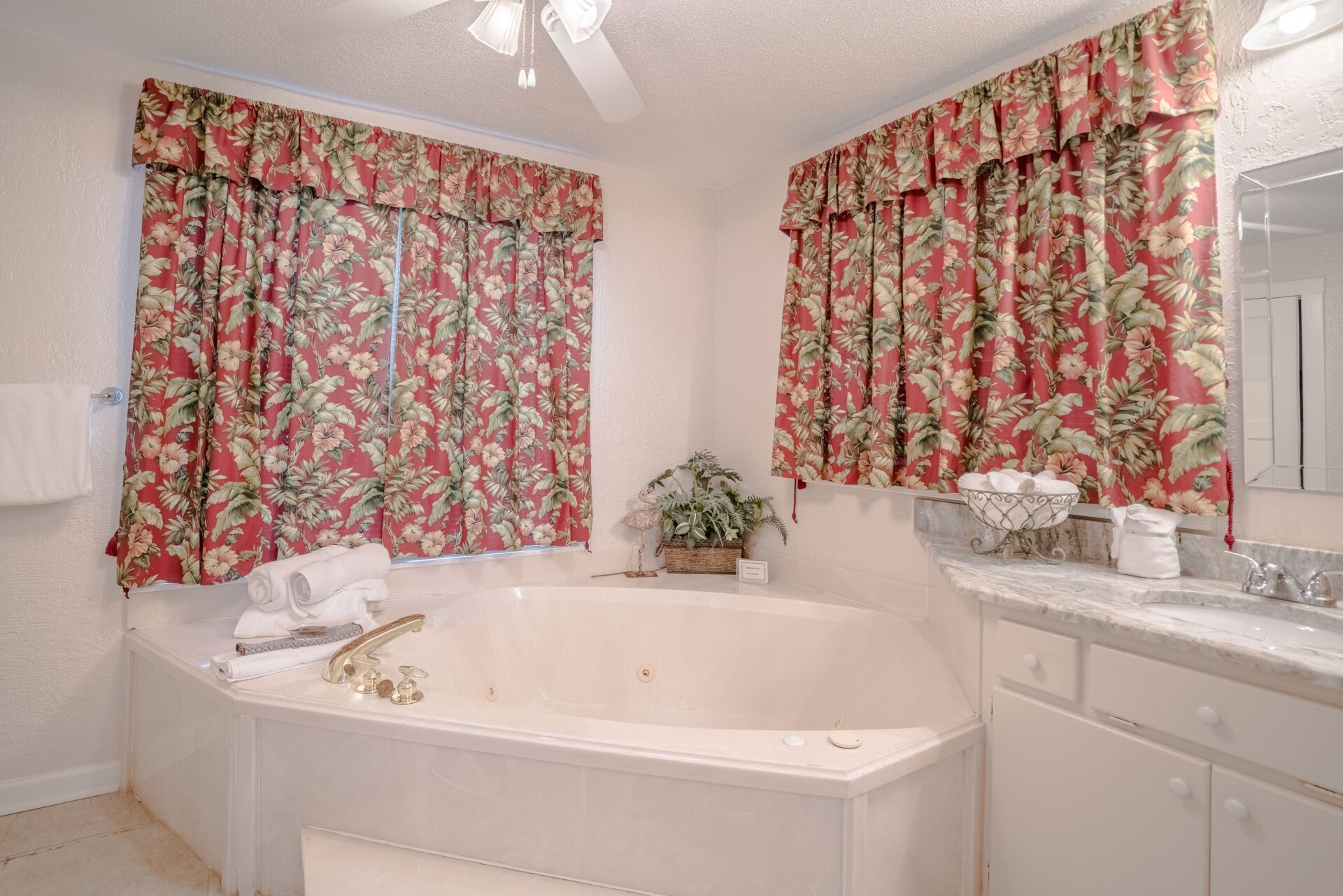 A bathroom with a jacuzzi tub and a sink.