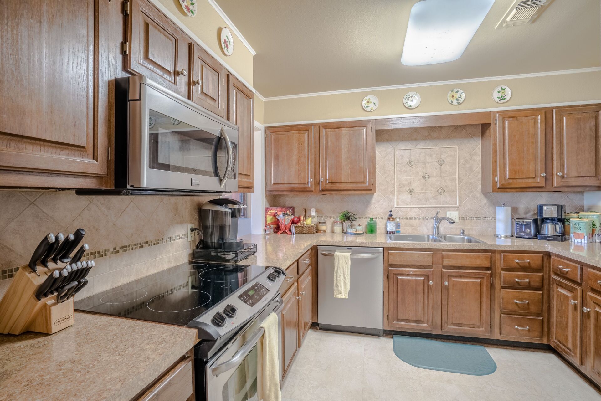 A kitchen with wooden cabinets and stainless steel appliances