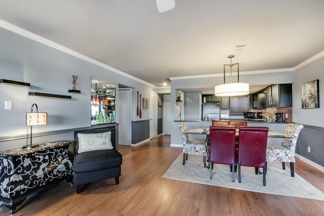 A living room with a dining room table and chairs