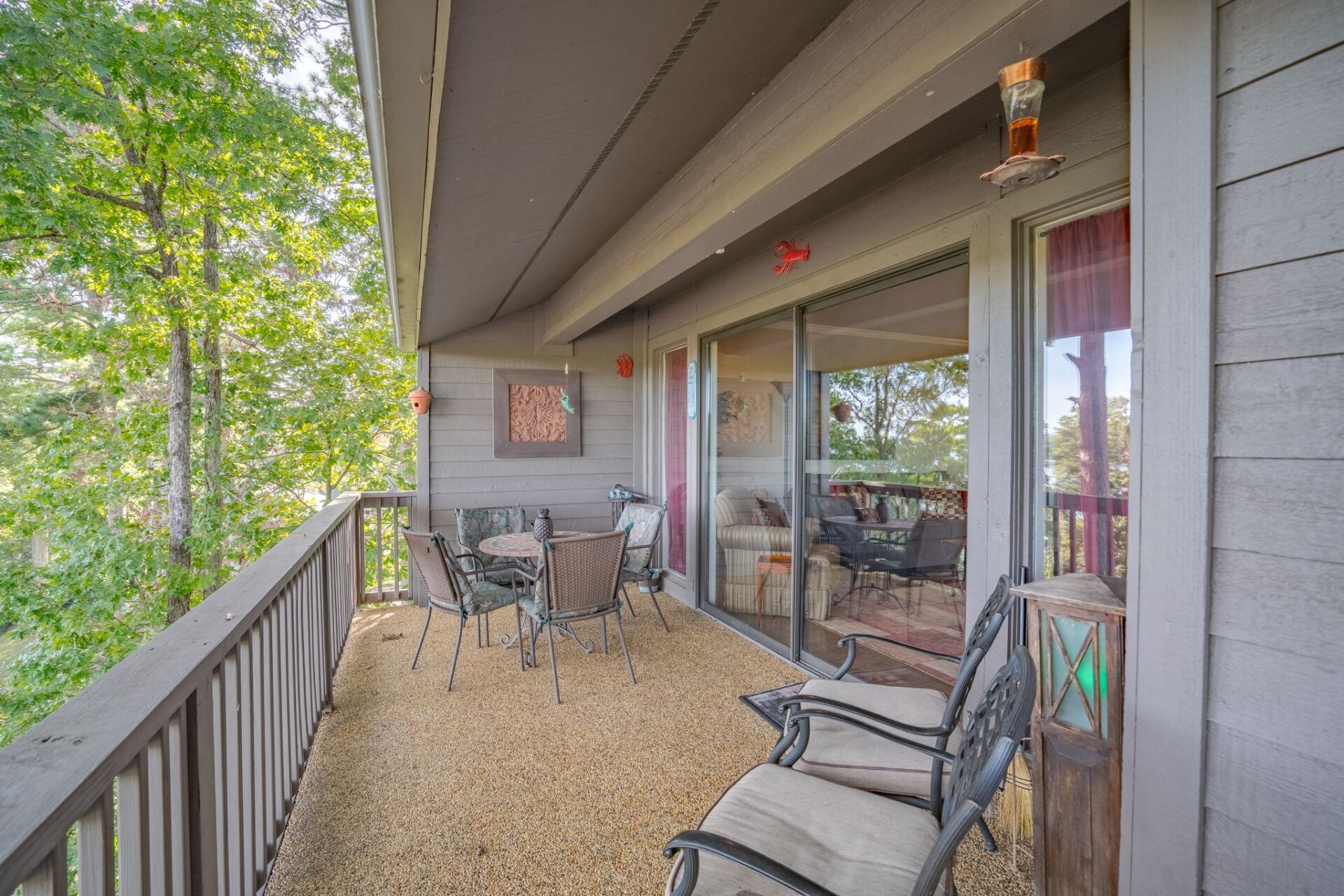 There is a large balcony with a table and chairs on it.