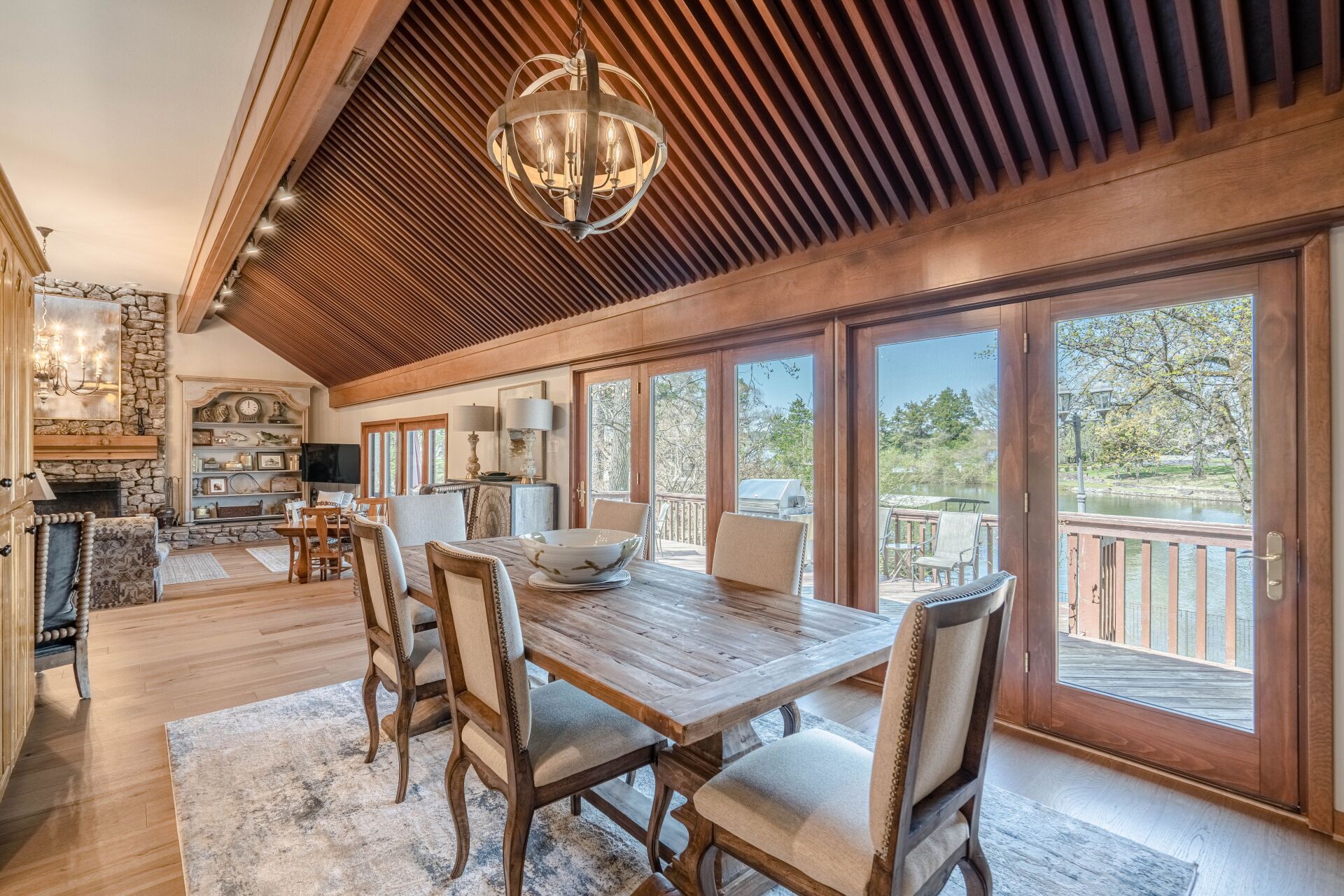 A large dining room with a wooden table and chairs and a chandelier.
