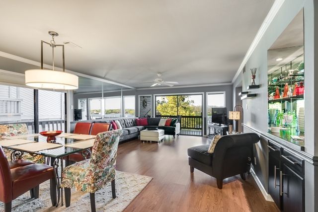 A living room with a dining table , chairs and a couch.