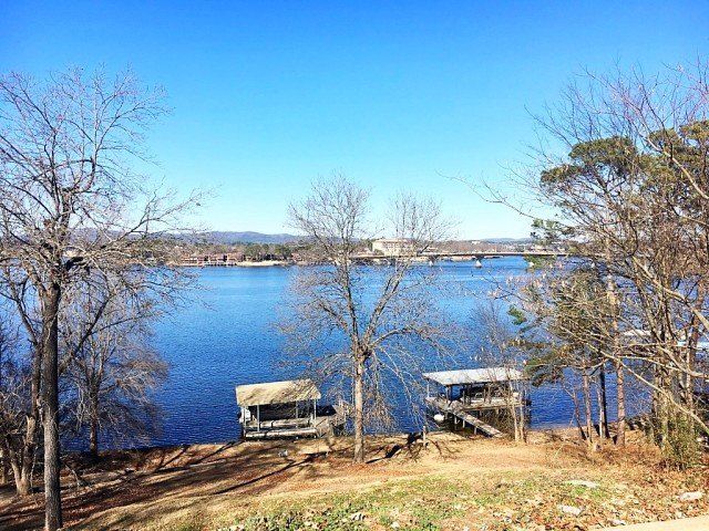 A large body of water surrounded by trees on a sunny day.