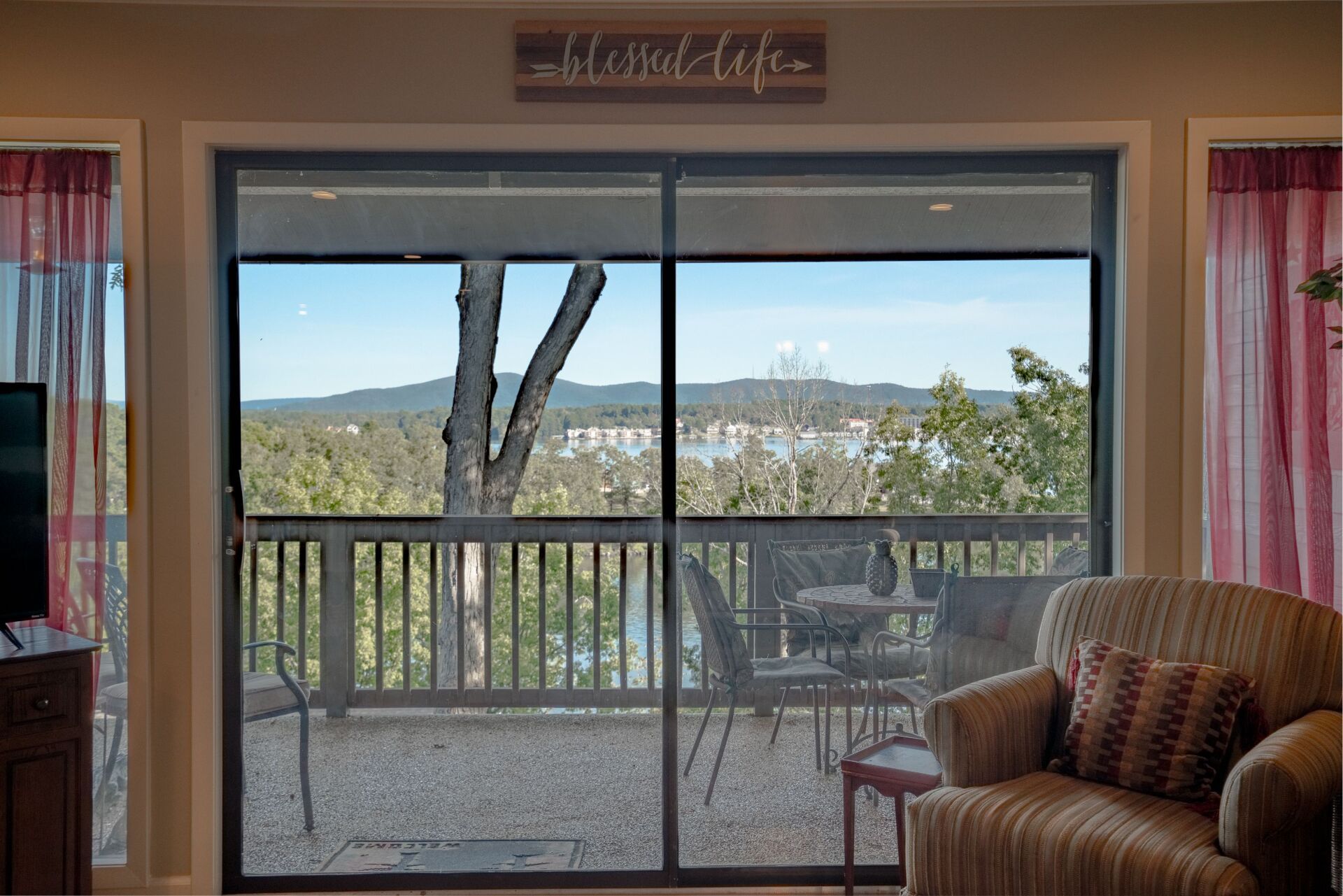 A living room with a sliding glass door leading to a balcony.