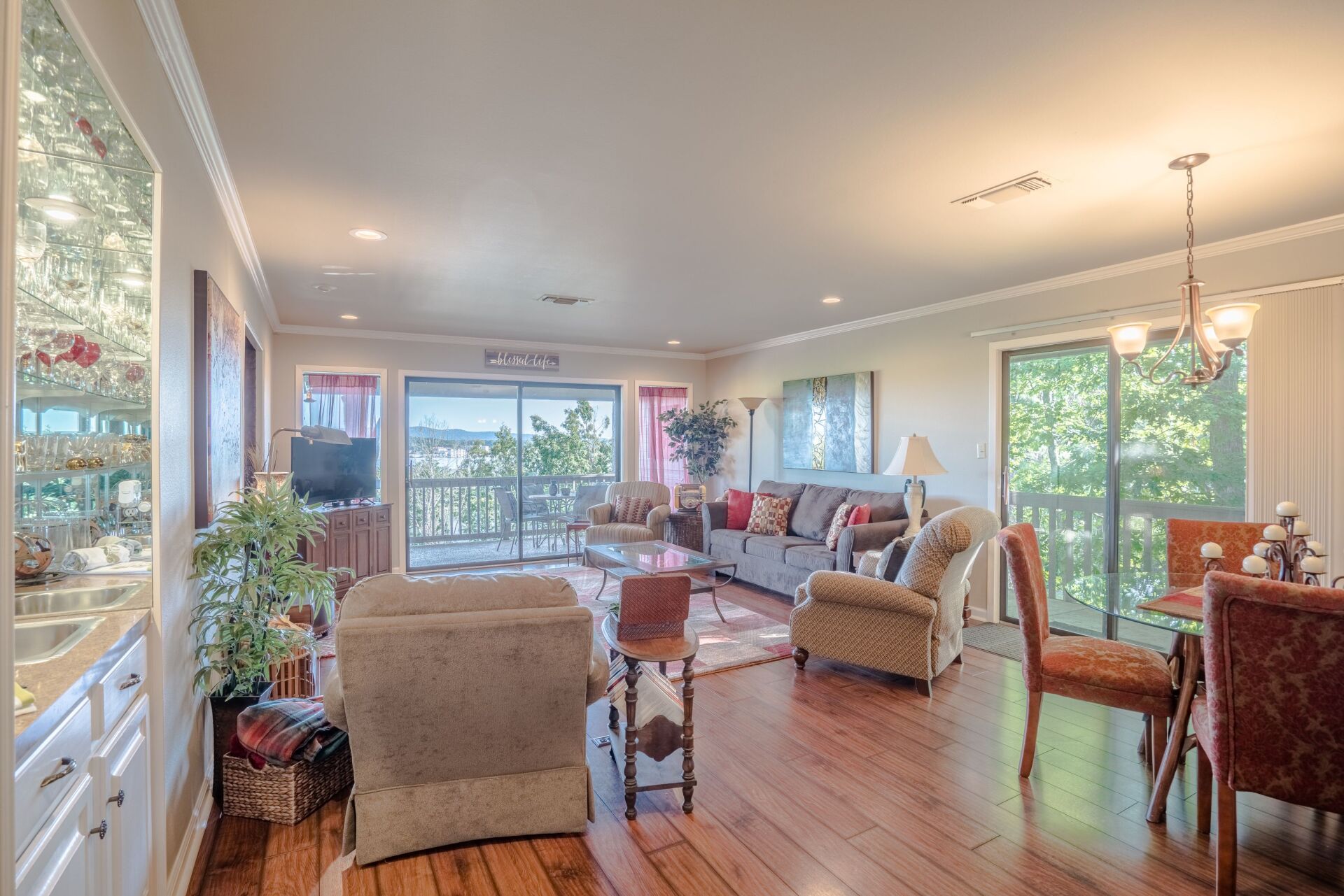 A living room with a couch , chairs , and a dining table.