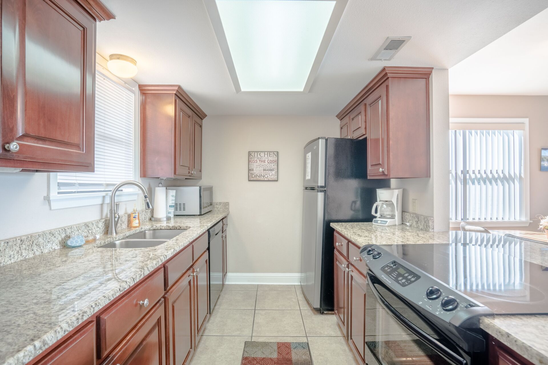 A kitchen with stainless steel appliances and granite counter tops