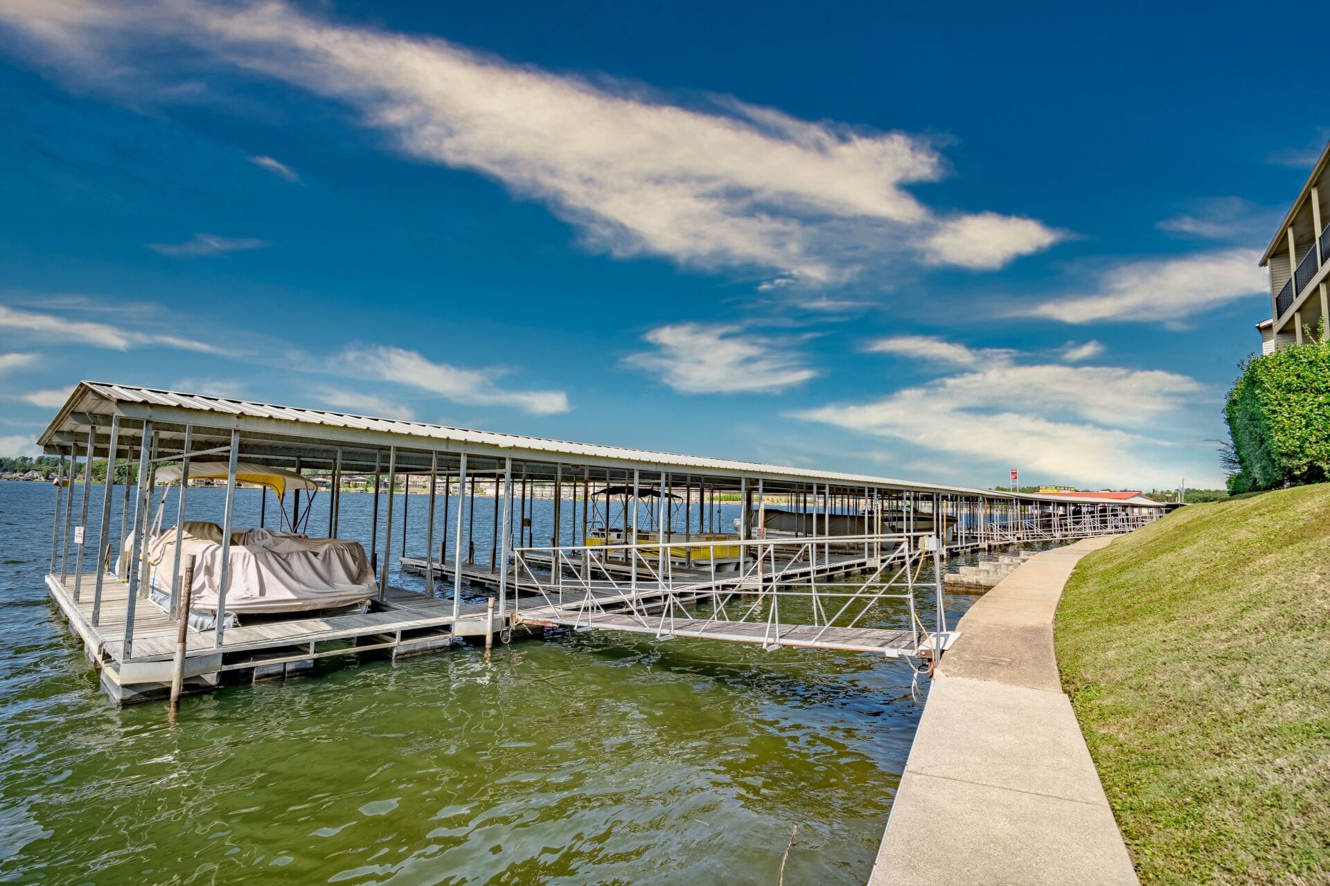 A boat is docked at a dock on a lake.