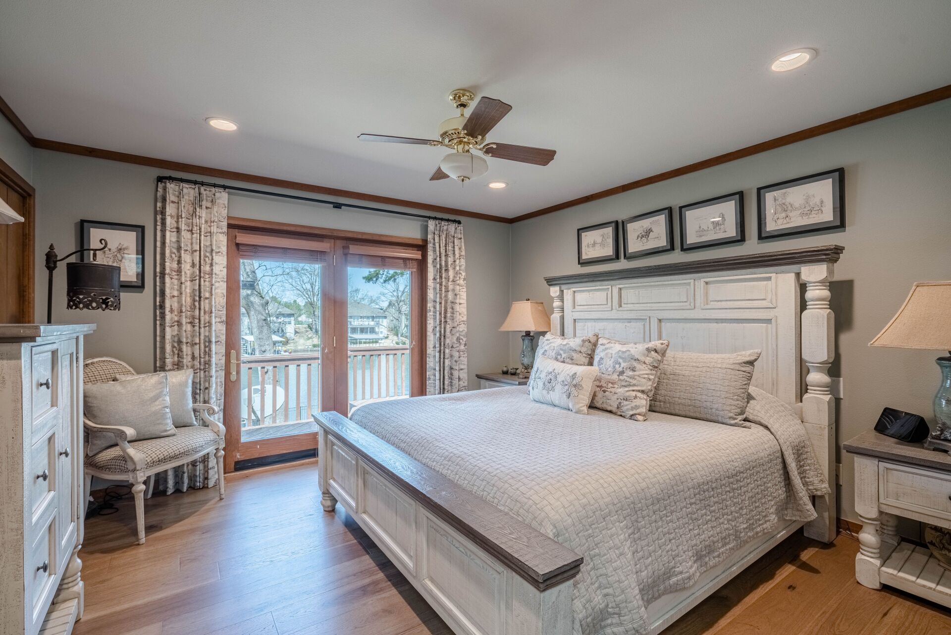 A bedroom with a king size bed and a ceiling fan.