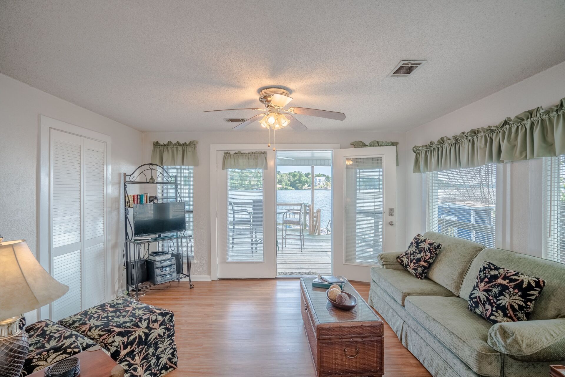 A living room with a couch and a ceiling fan