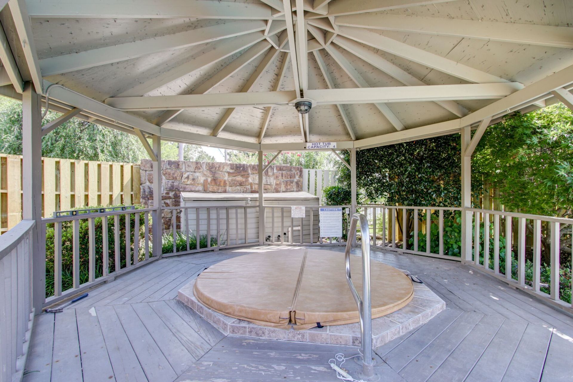 A gazebo with a hot tub inside of it.