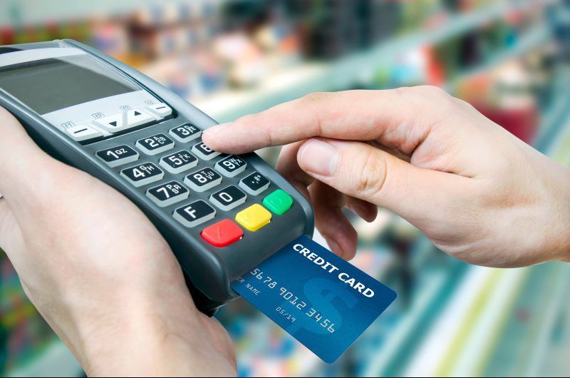 A person is using a credit card to pay for something