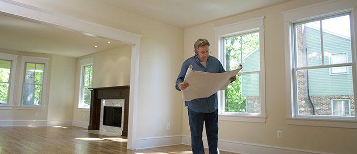 Contractor Checking Blueprints - Home Remodeling in Northern Onondaga County, NY
