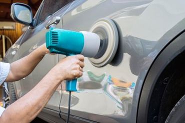 Auto Paintless Dent — Hands Polish A Car Body With Polisher in Edison, NJ Auto Paintless Dent — Hands Polish A Car Body With Polisher in Edison, NJ