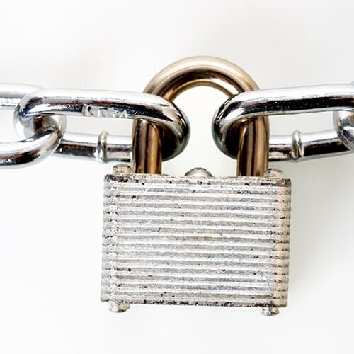 Metal padlock locked to chains - Lock Shop & Key Service in Morrisville, PA Metal padlock locked to chains - Lock Shop & Key Service in Morrisville, PA