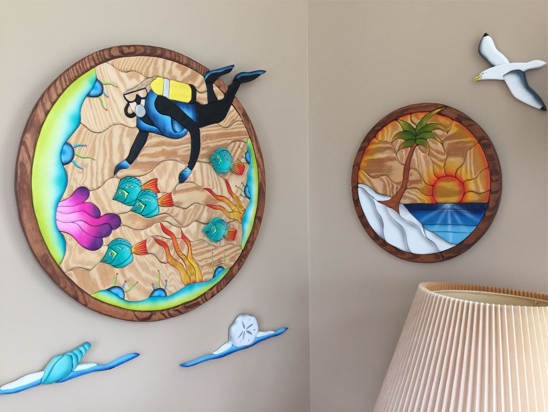 Intarsia art by Nick Vidakovic featuring scuba diver in reef, island sunset, and shells on the beach