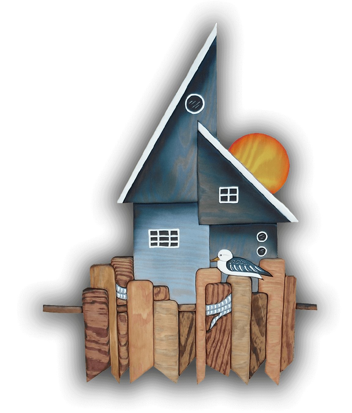 A custom Intarsia Art piece by Nick Vidakovic of a house with a seagull in front of it
