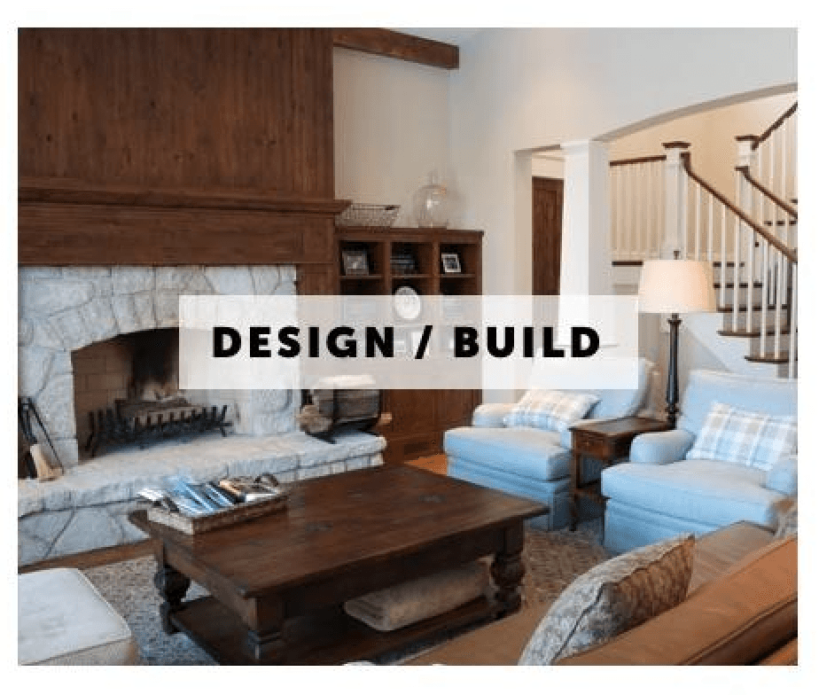 A living room with a fireplace and stairs and a sign that says design / build